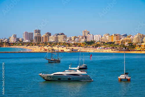 Beach and Skyline of Portimao, Algarve, Portugal as seen from Ferragudo, with Arade River upfront