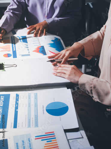 Above table with finance papers, graphs and big data during teamwork meeting with accounting or marketing team discussing budget, strategy or growth development. Closeup of SEO team doing research