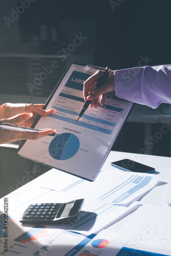 Above table with finance papers, graphs and big data during teamwork meeting with accounting or marketing team discussing budget, strategy or growth development. Closeup of SEO team doing research
