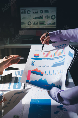 Above table with finance papers, graphs and big data during teamwork meeting with accounting or marketing team discussing budget, strategy or growth development. Closeup of SEO team doing research