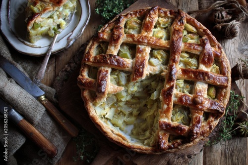 Leek and potato pie with creamy filling, tender leeks, and a crispy golden lattice top, styled in a British countryside setting

