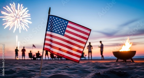 American flag on a beach with people and a fire pit during a 4th of july celebration