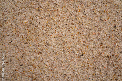 Coarse concrete texture with embedded pebbles on a wall in Orleans, France