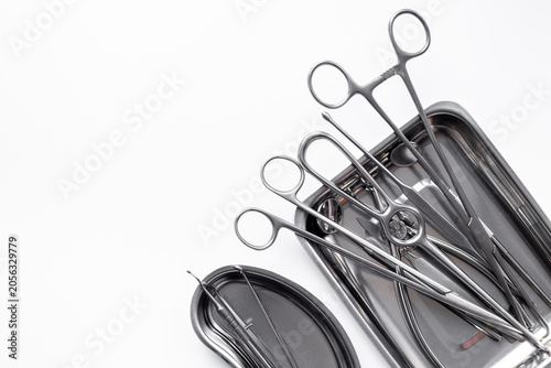 Sterile surgical instruments and tools - scalpels, scissors and others - in a stainless tray, top view