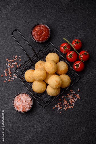 Cheese balls or potato croquettes, golden brown, fried with salt and spices. Cheese balls