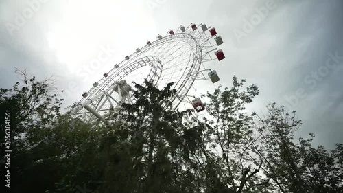 View of the Ferris wheel from below. Ferris wheel. Filmed in motion