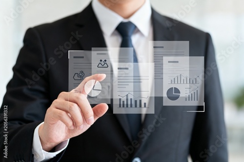 Businessman Interacting with Digital Data Charts