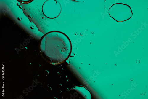 Abstract oil and water bubbles background with neon color gradient