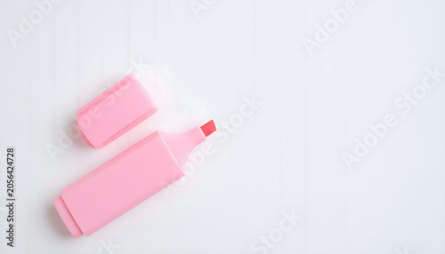 Single open pink pastel highlighter pen on clean white background with copy space