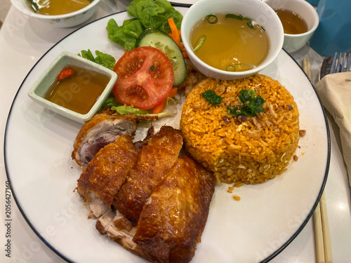 roasted chicken and seasoned rice plate with salad and soup top down view