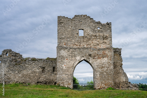 Canvas-taulu the dramatic, weathered stone ruins of an ancient castle gatehouse, featuring a