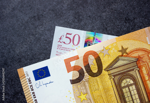 Fifty euros and fifty British pounds close-up. National currencies of Europe