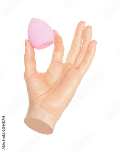 Woman hand holds cosmetic sponge, isolated on transparent background, cosmetics and visage concept. Contemporary art