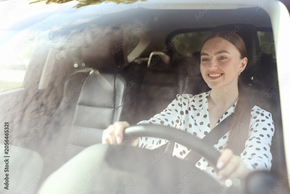 Obraz premium Woman driving modern car, view through windshield