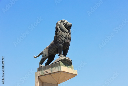 Fotografie The lion statue on the pillars of Stone Bridge in Saragossa, Aragon, Spain under