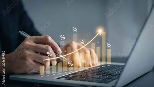 Business person using a laptop with digital growth chart and profit data hologram