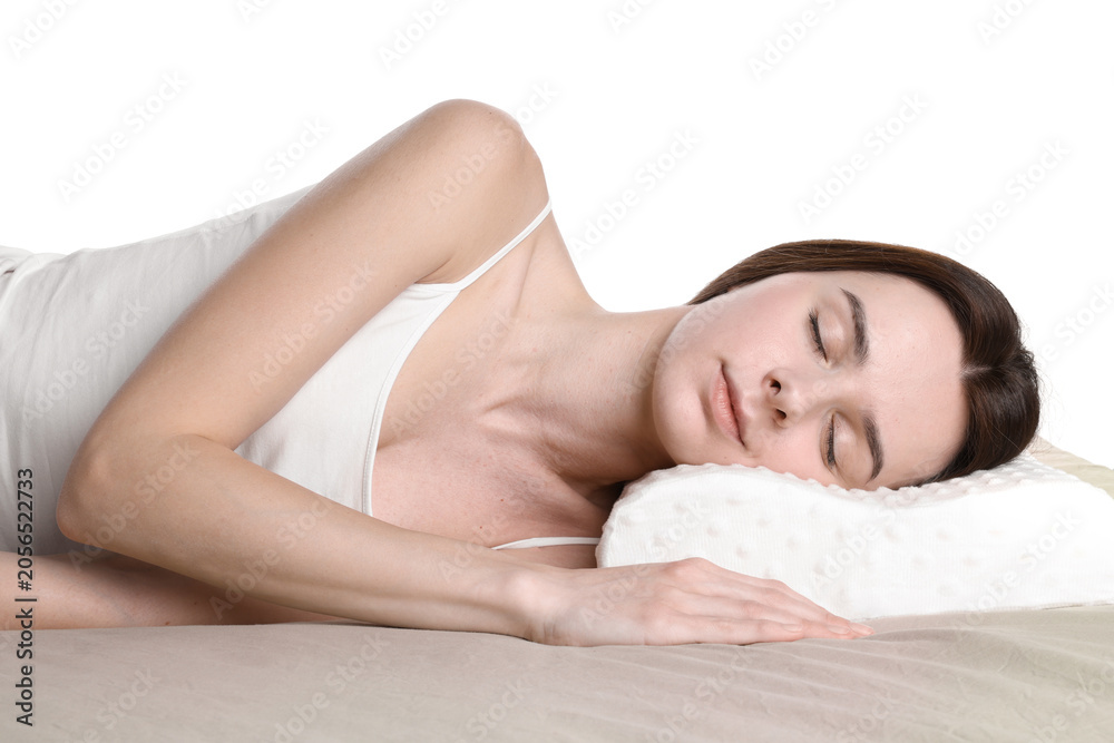 Obraz premium Woman sleeping on bed with orthopedic pillow against white background