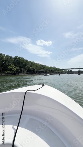 View from boat deck sailing along the Seine river in Paris on a sunny day
