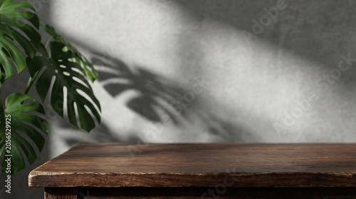 Dark wood table top with monstera leaf shadow for industrial home product display mockup and website banner.