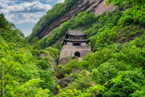 Ancient Jianmen Guanlou gate tower surrounded by steep mountain cliffs in Jianmen Pass, Sichuan, China