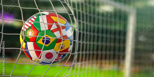 Football ball with flags of world countries in the net of goal of football stadium. World cup championship 2022.