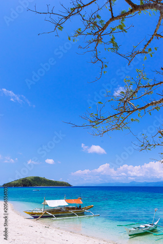 Tropical white sand on a sunny day at Alad Island. Romblon, Philippines