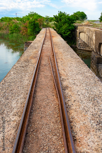 Narrow-gauge railway line on a bridge over a water channel for supplying water to the Burgas saltworks on the Bulgarian Black Sea coast