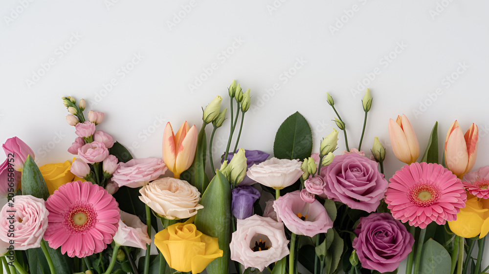 Fototapeta premium Assorted spring flowers arranged naturally with soft natural lighting for commercial use