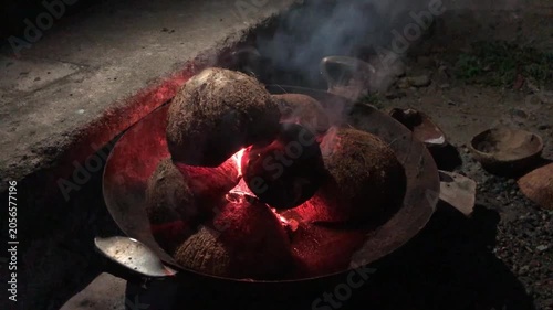 burning dried coconut  on a stove