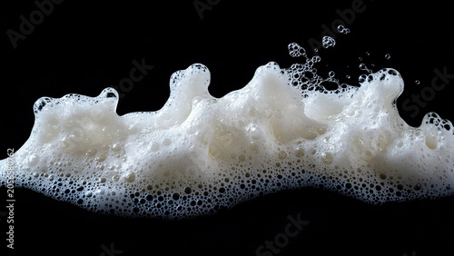 white soap foam splash isolated on black background 