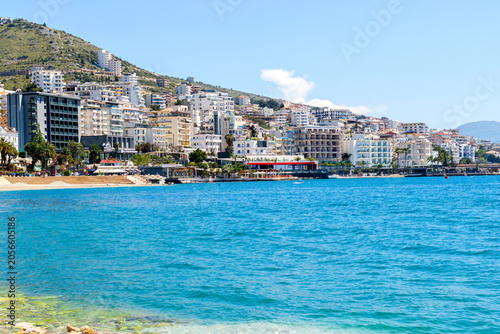 Beautiful beach with white pebbles and blue waters in european city.
