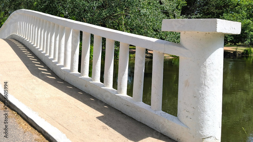 Canvastavla Close-Up of White Balustrade Railing on Park Bridge Overlooking Green Lake and T