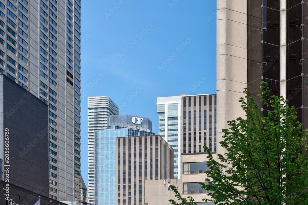 Naklejka premium View of a CF Cadillac Fairview sign mounted on the top of an office building surrounded by high-rise towers in downtown Toronto, highlighting commercial real estate and urban architecture, May 2026