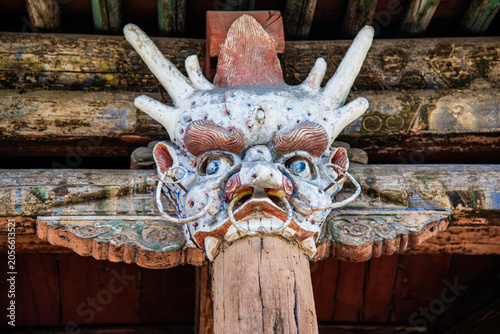 Tableau sur toile Yungang, China - May 9 2026: An intricate, weathered dragon head wood carving se