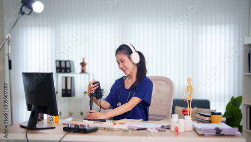 фотографія Young Asian woman podcaster recording episode with professional microphone and h