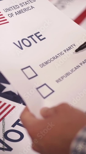 A U.S. citizen holding a ballot at a polling station during the U.S. Congressional midterm elections