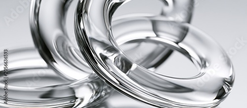 Close-up of shiny chrome metal rings and loops on white background