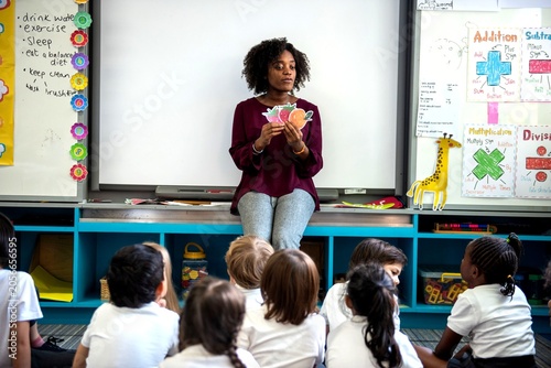 Teacher engaging diverse young students.