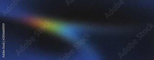 A narrow band of yellow, green, and blue light spectrum forms an abstract diagonal streak on a dark, grainy background, suggesting clarity and focus.