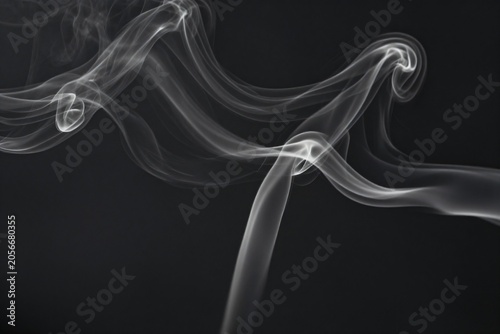 Fotografija Elegant white smoke swirls on dark charcoal background, delicate flowing wisps w
