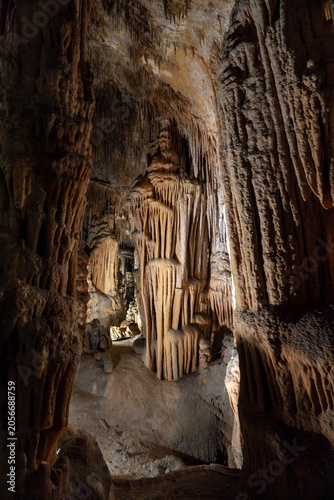 Brown cave interior with stalactites and stalagmites natural rock formations