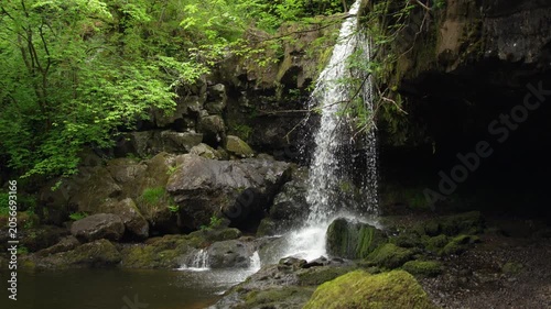 Scenic Woodland Waterfall Cascading into Stream Pool