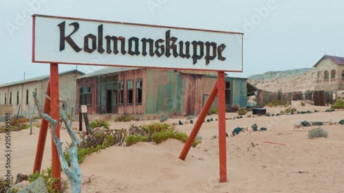 Abandoned ghost town Kolmanskop welcome sign in Namibia