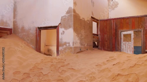 Abandoned house in Kolmanskop ghost town slowly filling with desert sand