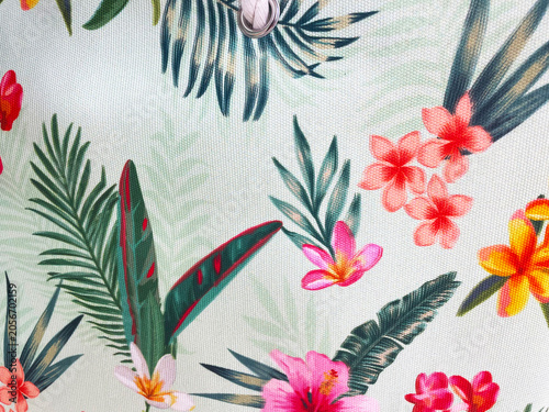 Tropical floral fabric pattern with colorful exotic flowers and lush green leaves on a light background. Vibrant botanical textile design ideal for fashion, decor, wallpaper and packaging.