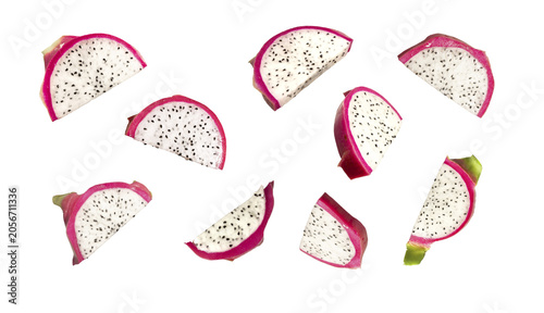 Dragon fruit pitahaya wedge slices set isolated on white background. Fresh tropical exotic fruit pieces scattered, food photography..
