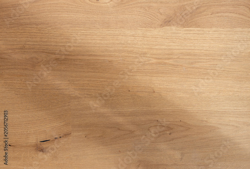 Natural oak wood texture background with smooth grain pattern. Light brown wooden surface close-up, clean and minimal..