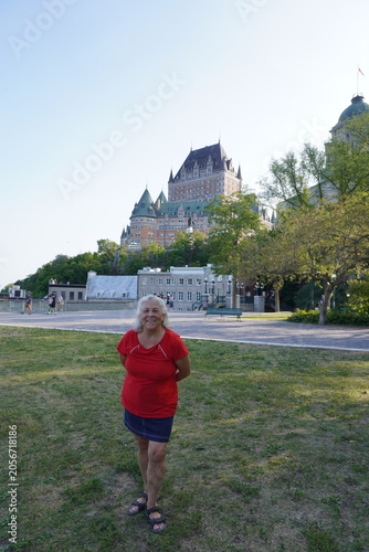 senior woman taking a picture in front of frontenac castle