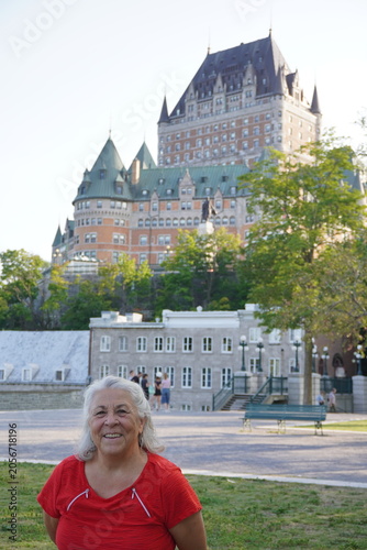 senior woman taking a picture in front of frontenac castle