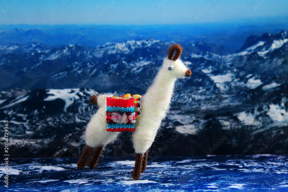Naklejka premium Llama or alpaca handicrafts in a mountain landscape
